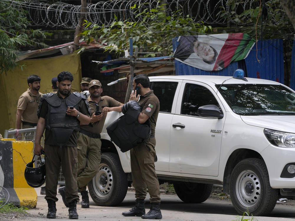 Police officers prepare to take position outside the residence of Pakistan's former Prime Minister Imran Khan, in Lahore, Pakistan, on Saturday, Aug. 5, 2023.