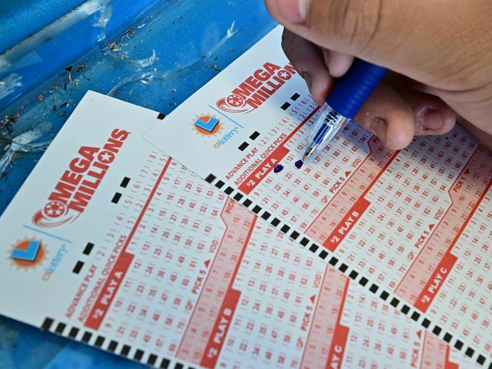 Numbers on tickets for the Mega Millions lottery are selected by a purchaser in Los Angeles on Friday.