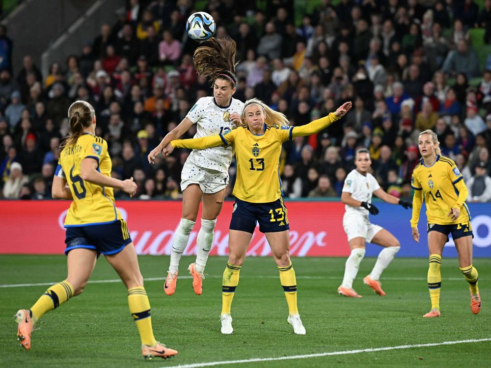 U.S. forward Alex Morgan (center) heads the ball next to Sweden's defender Amanda Ilestedt in the 89th minute of their Women's World Cup matchup on Sunday.