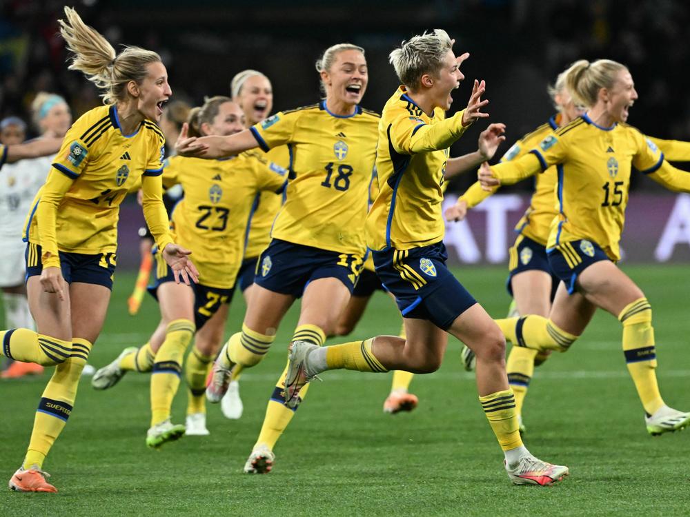 Sweden's forward #08 Lina Hurtig (center) and teammates celebrate their win following a penalty kick shootout over two-time defending champion U.S. at the Women's World Cup. It was the U.S.'s earliest exit from the tournament.