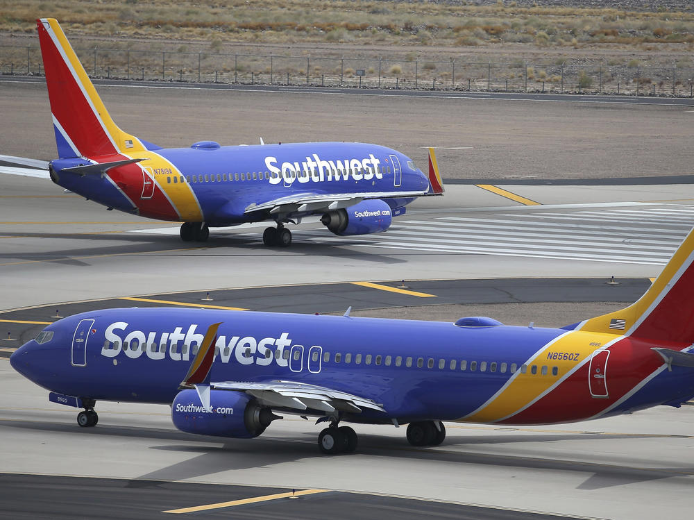 Southwest Airlines planes taxi at Phoenix Sky Harbor International Airport in July 2019. Southwest is facing a discrimination suit after an employee allegedly reported a passenger to police on suspicion of child trafficking.