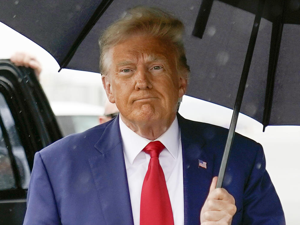 Former President Donald Trump walks to speak with reporters before boarding his plane at Ronald Reagan Washington National Airport on Aug. 3 in Arlington, Va.