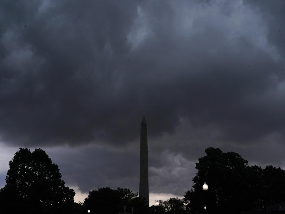 Storm clouds darken the sky over the Washington Monument on Monday after thousands of federal employees were sent home early amid a tornado watch in the Washington, D.C., region.