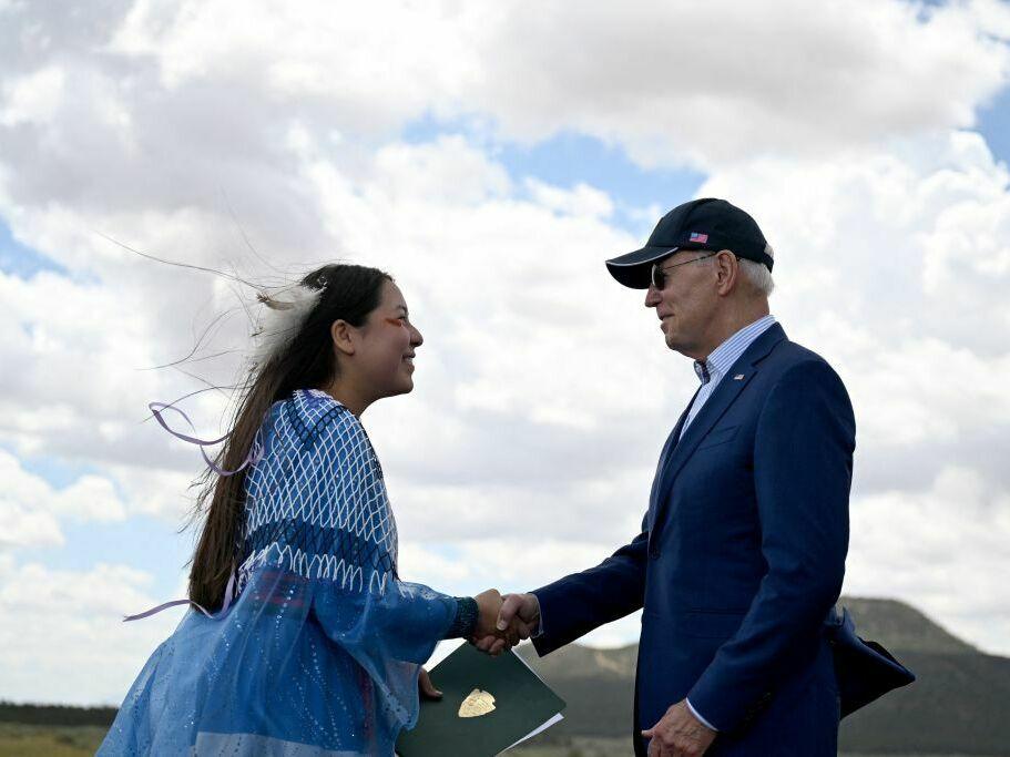 Maya Tilousi, member of the Hopi Tribe, Havasupai Tribe of Grand Canyon, and the Cheyanne and Arapaho Tribes, shakes hands with President Biden after introducing him at Red Butte Airfield, 25 miles south of Tusayan, Ariz., on Tuesday.