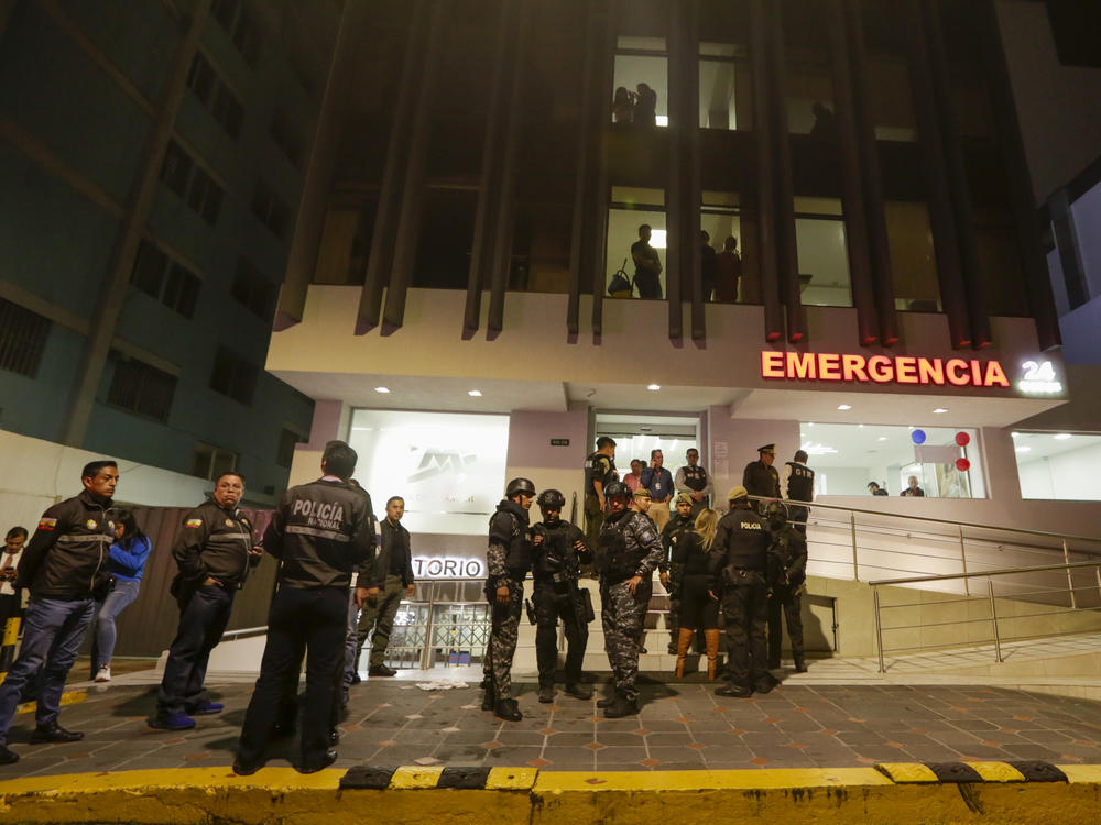 Police guard the hospital where several of the injured were taken after an attack against presidential candidate Fernando Villavicencio in Quito, Ecuador, on Wednesday.