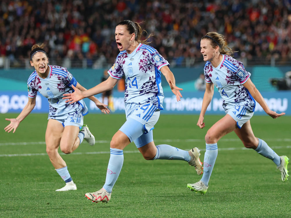 Spain's Laia Codina (center) celebrates with teammates Esther Gonzalez (left) and Irene Paredes (right) after scoring her team's fourth goal on Switzerland during the round of 16.
