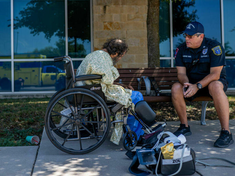 Austin-Travis County EMT Captain C. Quiroz helps a patient dealing with heat-related symptoms in Austin, Texas, this week. People with other health problems are especially vulnerable to heat.