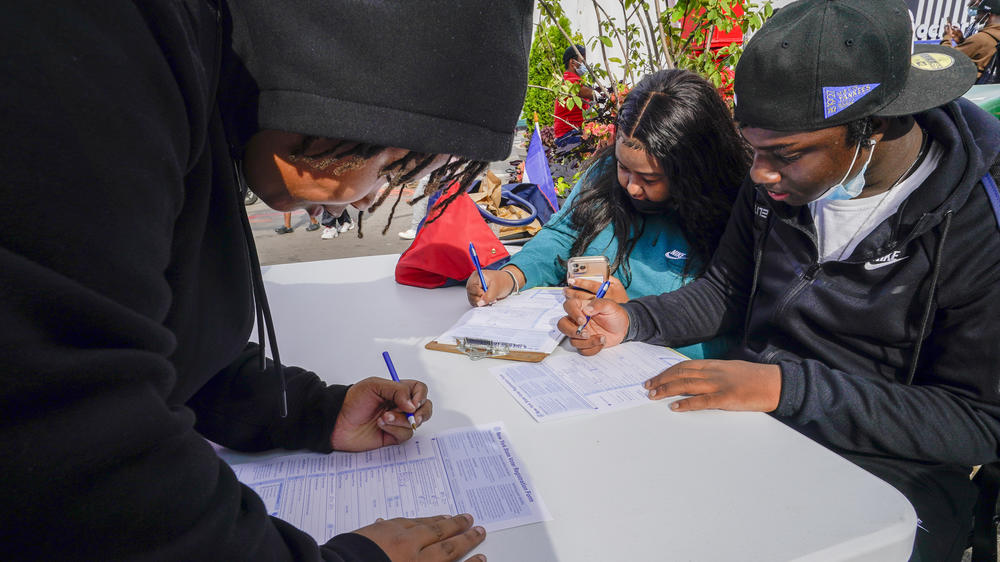 Residents of Brooklyn's Flatbush neighborhood register to vote at a voter registration event on Sept. 29, 2021.