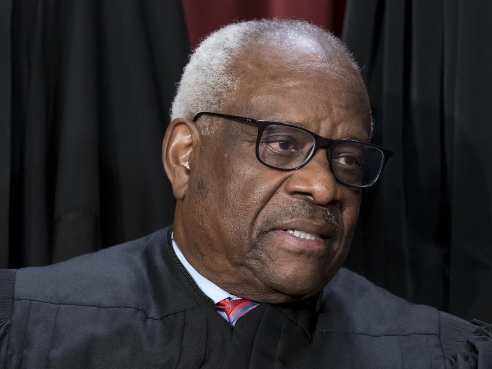 Associate Justice Clarence Thomas joins other members of the Supreme Court as they pose for a group portrait on Oct. 7, 2022.