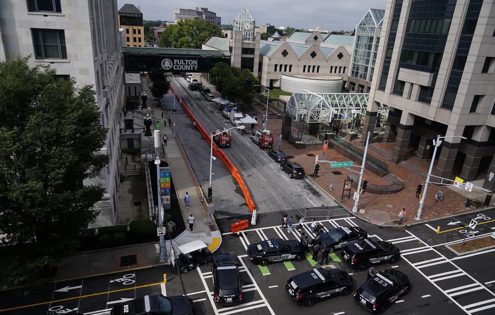 Police vehicles are seen near security barricades at the Fulton County courthouse on Aug. 7 in Atlanta.