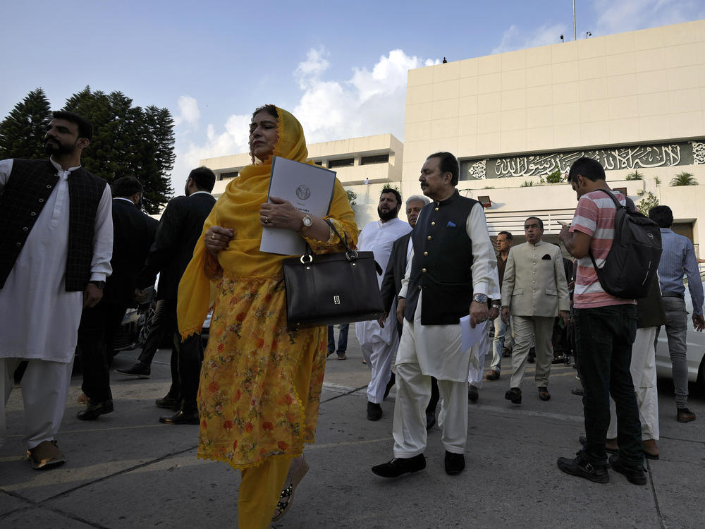 Lawmakers of the National Assembly arrive for a group photo with Pakistan's Prime Minister Shehbaz Sharif at the end of the last session of the current parliament, in Islamabad, Pakistan, Wednesday, Aug. 9, 2023.