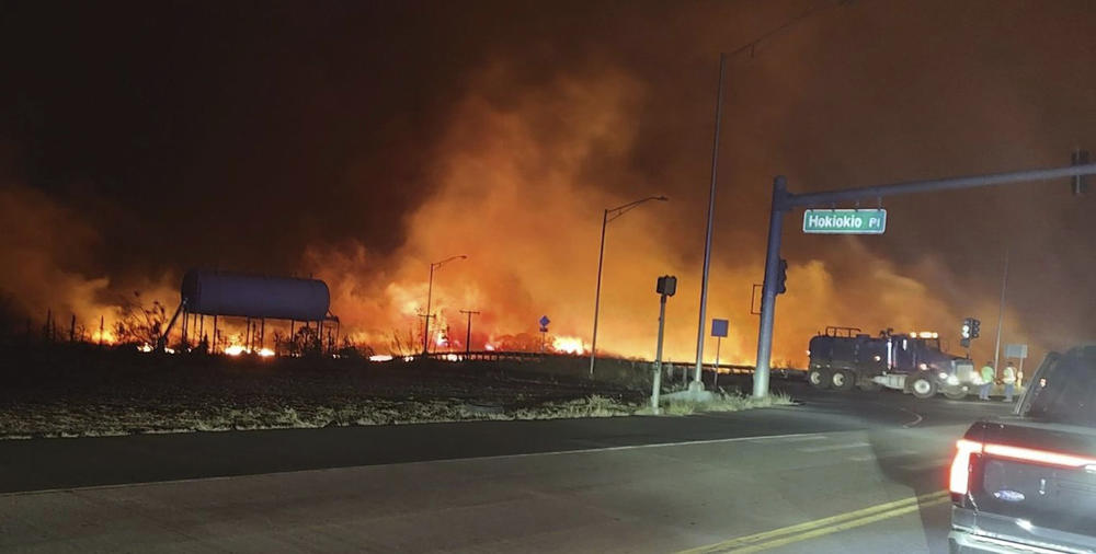 August 8: This photo provided by County of Maui shows fire and smoke filling the sky from wildfires on the intersection at Hokiokio Place and Lahaina Bypass in Maui, Hawaii.