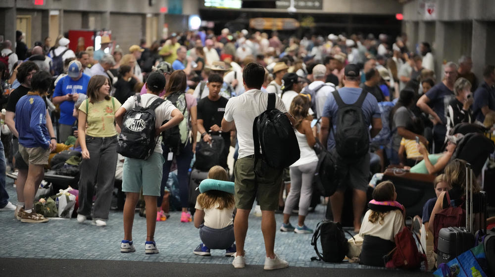 August 9: People gather at the Kahului Airport while waiting for flights Wednesday, in Kahului, Hawaii.