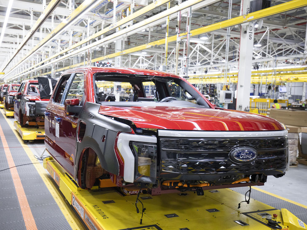 Ford F-150 Lightning pickup trucks sit on the production line at the Ford Rouge Electric Vehicle Center in Dearborn, Mich., on April 26, 2022. Ford is willing to sell the electric version of its top-selling model at a loss for now in order to gain market share.