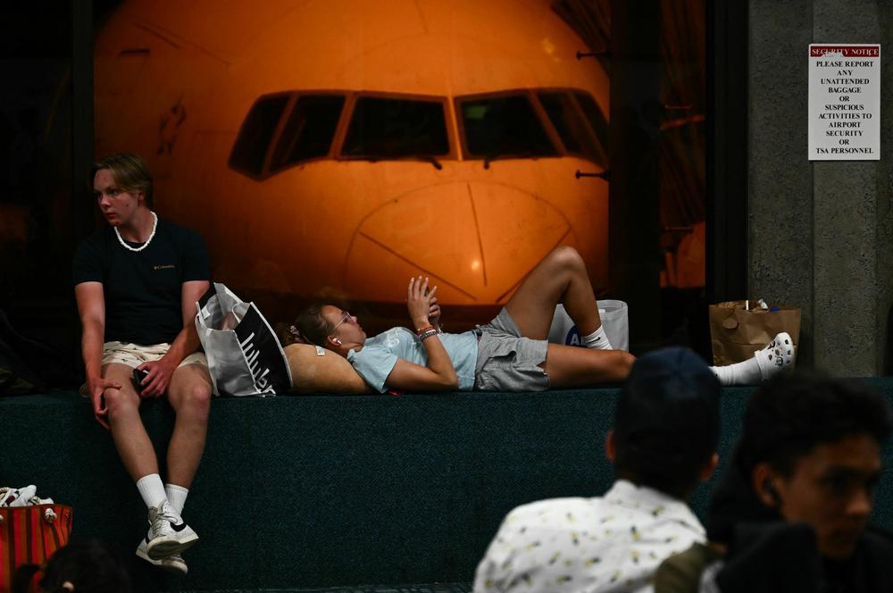 August 9 - Passengers wait for delayed and canceled flights off the island as thousands of passengers were stranded at the Kahului Airport in the aftermath of wildfires in western Maui.