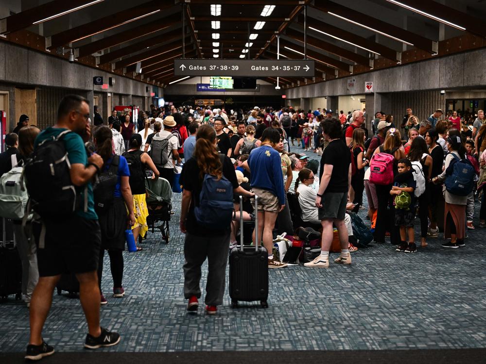 Passengers wait for flights out of Kahului Airport in western Maui in Kahului, Hawaii on Wednesday.