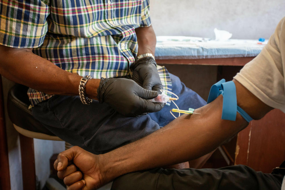 Kenneth Pierson conducts a blood test in the van. The SPOT vans are staffed with nurse practitioners who can draw blood, conduct tests, prescribe medication and provide some primary care.