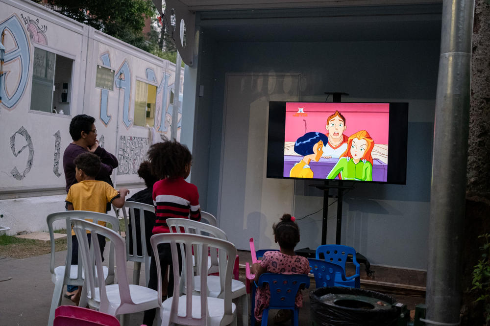 Children watch TV at a facility for formerly homeless families in São Paulo.