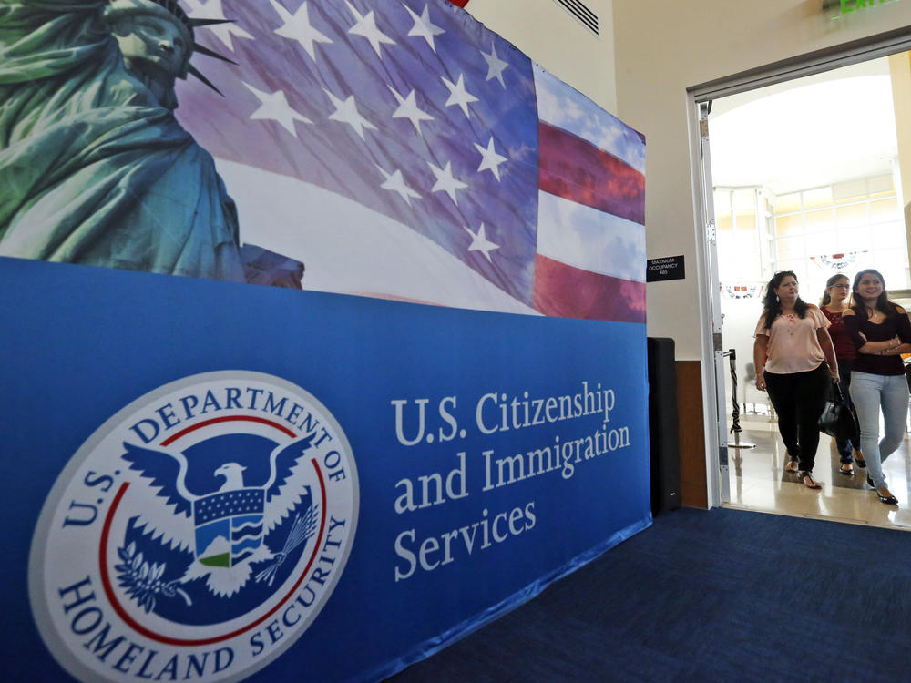 FILE - In this Aug. 17, 2018, file photo, people arrive before the start of a naturalization ceremony at the U.S. Citizenship and Immigration Services Miami Field Office in Miami. One supposed feature of the U visa program is a faster track to citizenship. (AP Photo/Wilfredo Lee, File)