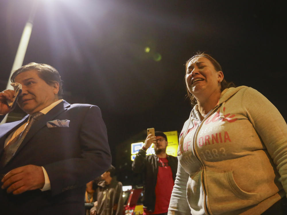 Supporters of presidential candidate Fernando Villavicencio cry outside the hospital where he was taken after he was shot to death while at a campaign rally in Quito, Ecuador, Wednesday, Aug. 9, 2023.