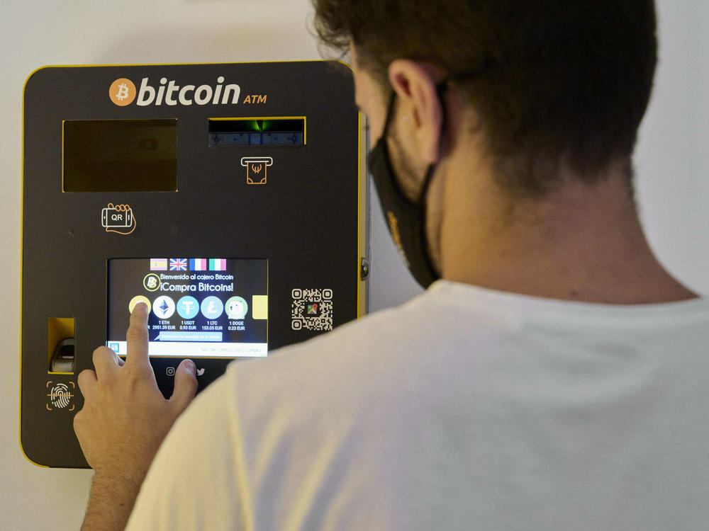 An employee demonstrates how the Bitcoin ATM works at the BitBase Store in Palma de Mallorca, Spain, on on August 9, 2021. Cryptocurrencies such as bitcoin are starting to become more popular.