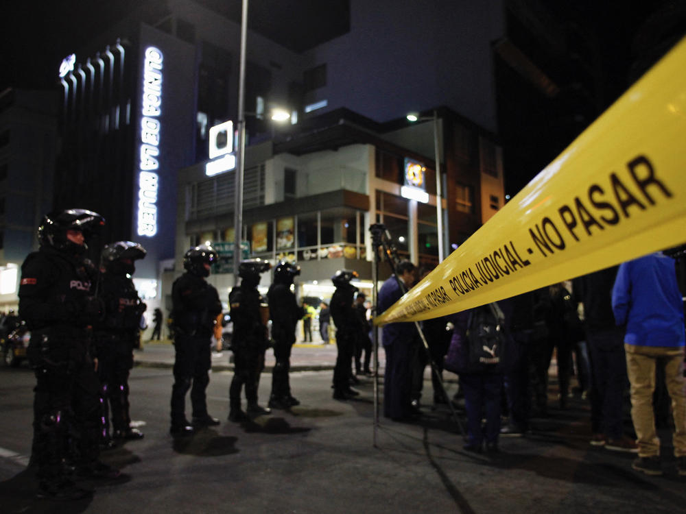 Police stand guard outside the hospital where presidential candidate Fernando Villavicencio was taken after being shot in Quito on Wednesday.