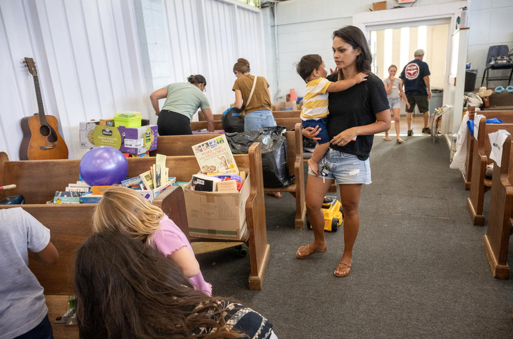 Emily Komatsu (right) with her son, Nehemiah Komatsu, volunteers at Waiehu Community Church partnering with Kahului Baptist church to collect and sort donations for relief to people affected by the deadly wildfires in Maui.