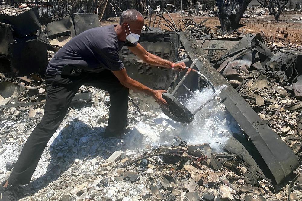 Anthony M. La Puente, 44, recovers items from his house in  Lahaina.
