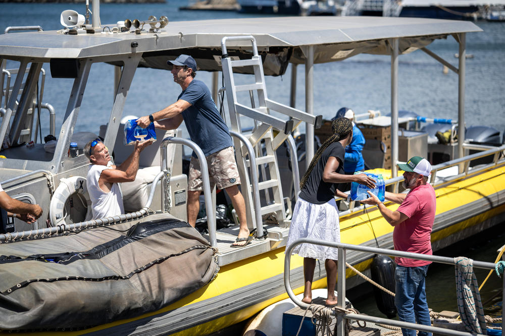 Volunteers load donated items onto Maui Reef Adventures' boat to be distributed to people in Lahaina.
