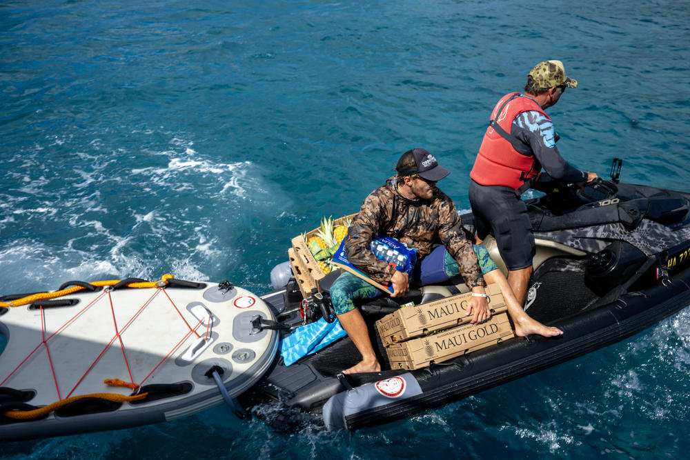 L to R: Cody Young and  Scott Sanchez from the local surfing community are shuttling donated items on jet boats to get them from large boats to the shore on the north side of Lahaina.