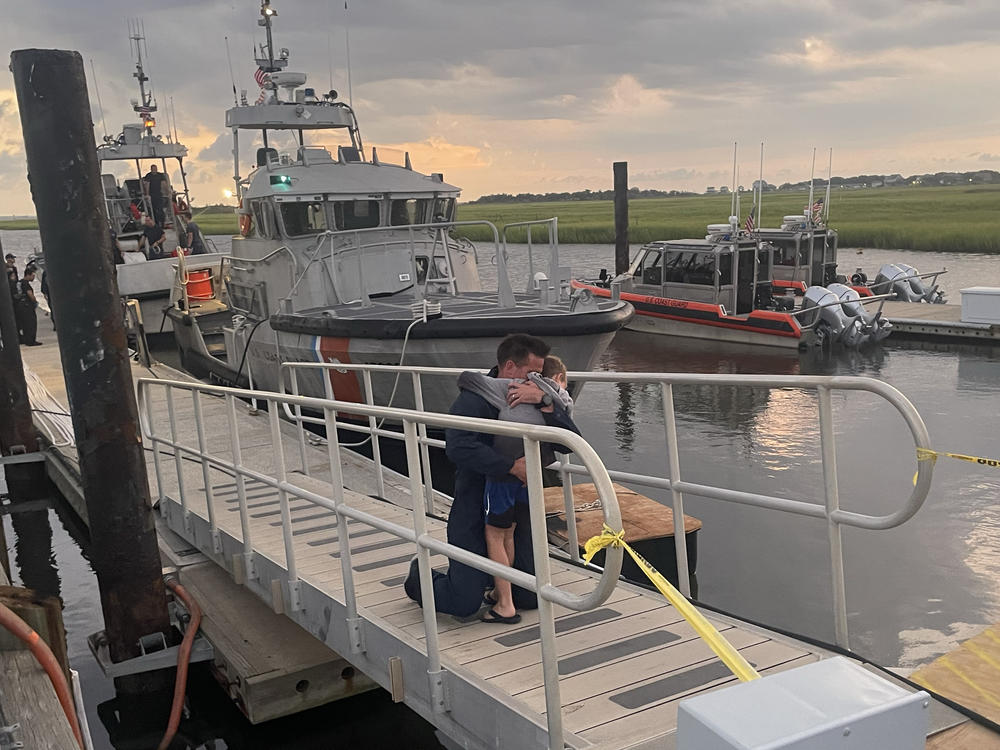 The U.S. Coast Guard and U.S. Navy brought four divers back to their families after a search aircraft spotted an SOS strobe.