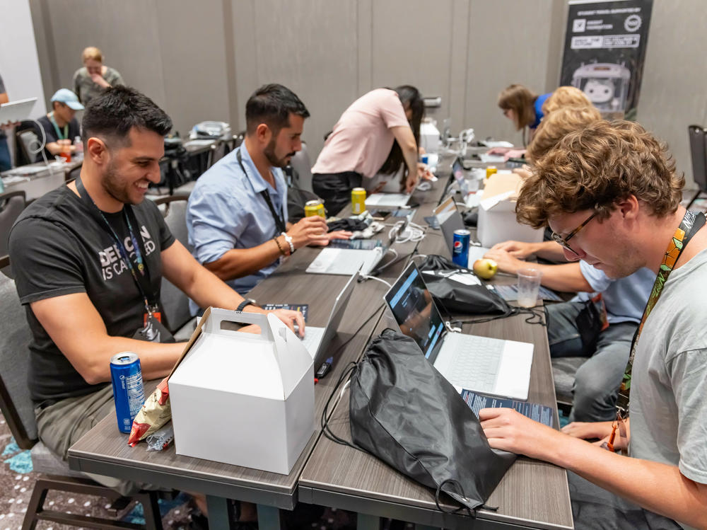 Participants at the 2023 Def Con hacker convention, trying to subvert AI chatbots as part of a contest to test the systems' vulnerabilities.