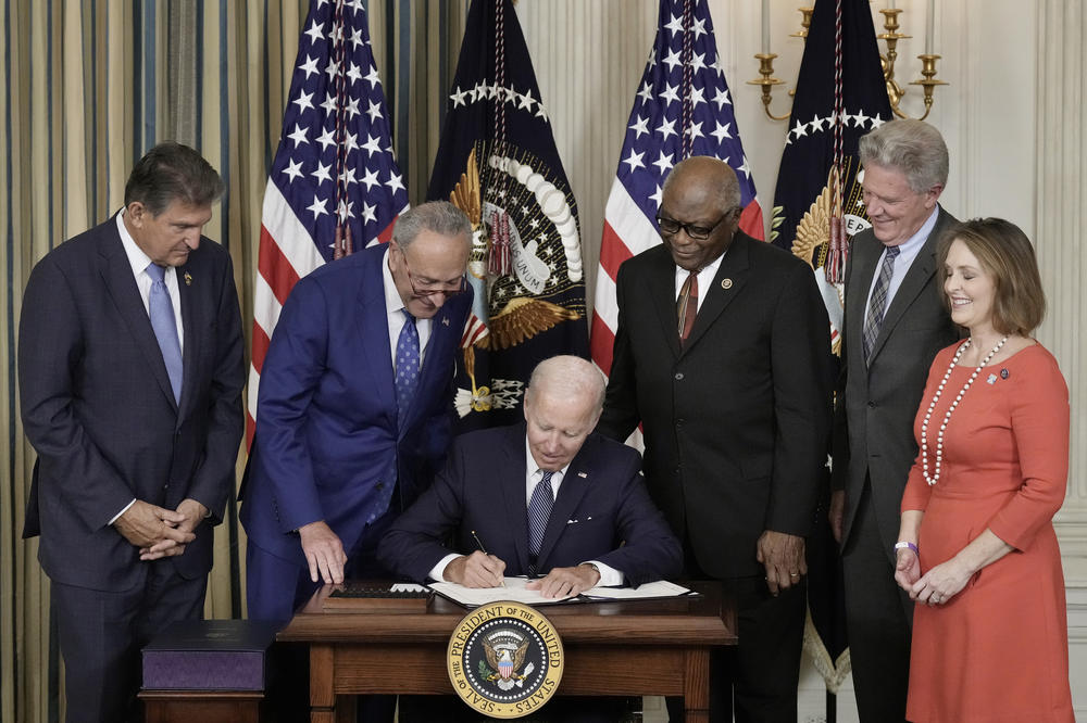 President Biden signs the Inflation Reduction Act with (from left) Sen. Joe Manchin, D-W.Va., Senate Majority Leader Charles Schumer, D-N.Y., House Majority Whip James Clyburn, D-S.C., Rep. Frank Pallone, D-N.J., and Rep. Kathy Castor, D-Fla., in the State Dining Room of the White House on Aug. 16, 2022.