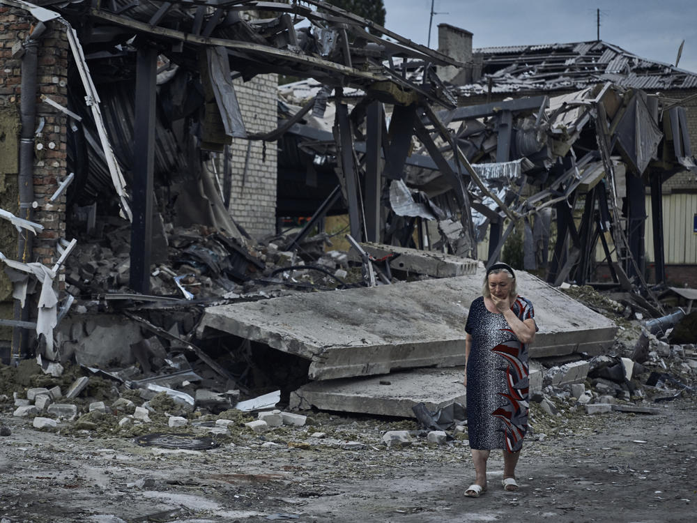 A woman at the scene of a building damaged after Russian missile strikes in Pokrovsk, Donetsk region, Ukraine, Aug. 9.