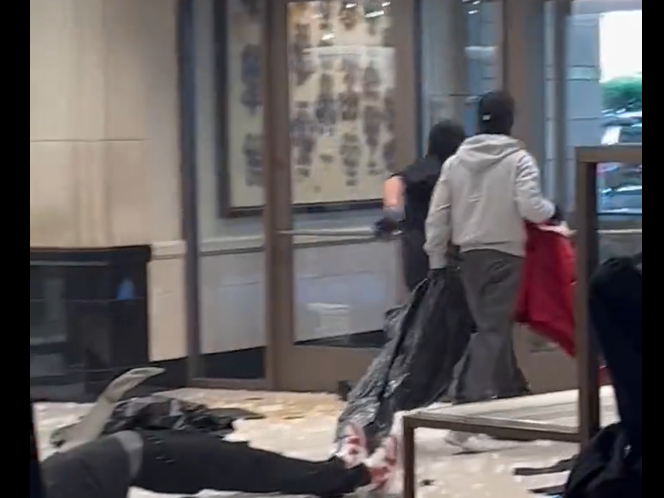 A screenshot of video posted by @noelskeez on X, formerly known as Twitter, shows masked robbers ransacking the department store in Topanga, Calif.