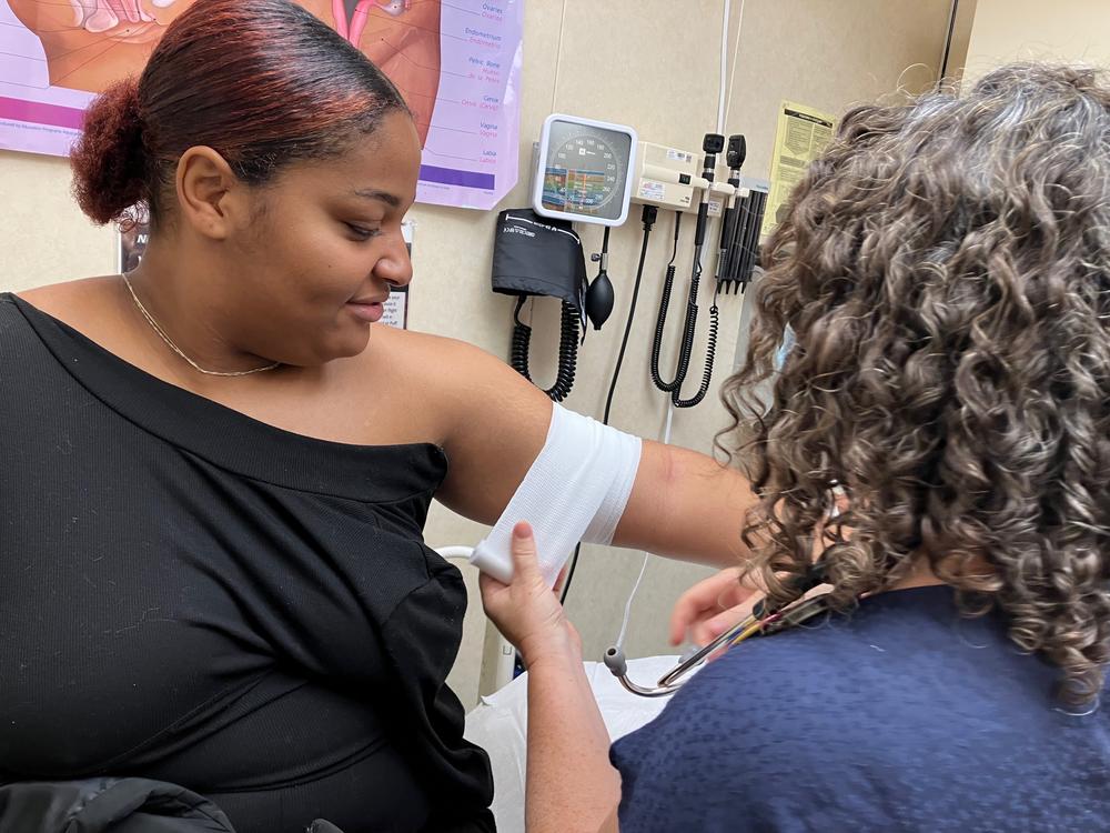 Nurse practitioner Arin Kramer bandages I'laysia Vital's arm after inserting a contraceptive implant that will last up to five years.