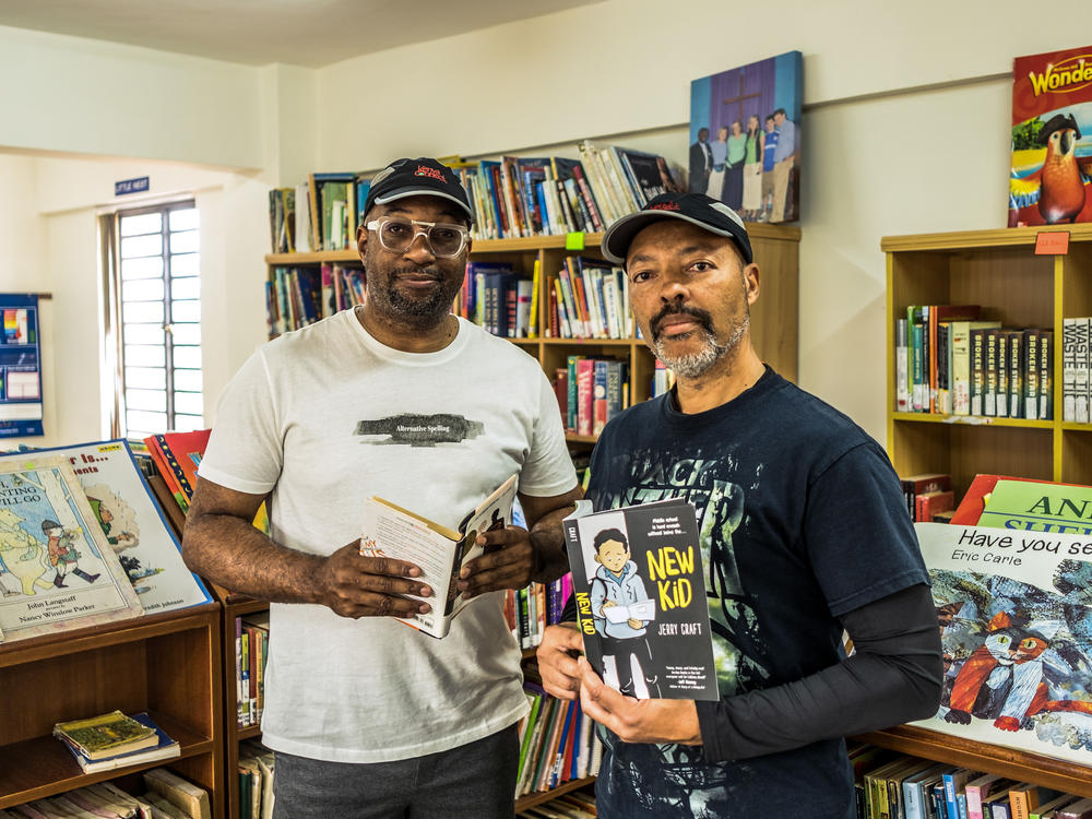 Kwame Alexander (left) and Jerry Craft have each won a Newbery Medal for their children's books. Alexander invited Craft on a trip to Kenya this summer to speak to schoolkids about reading. The kids were impressed. So were the authors.