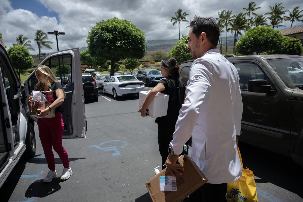 Nurses (from left) Abby Cobb and Jennifer Stadig help Dr. Reza Danesh pack the van. The deadly wildfires in Maui largely destroyed the historic community of Lahaina.