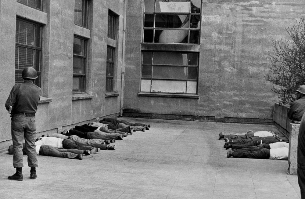 People lie on the ground after being arrested by the military during the coup on Sept. 11, 1973, in Santiago, Chile.