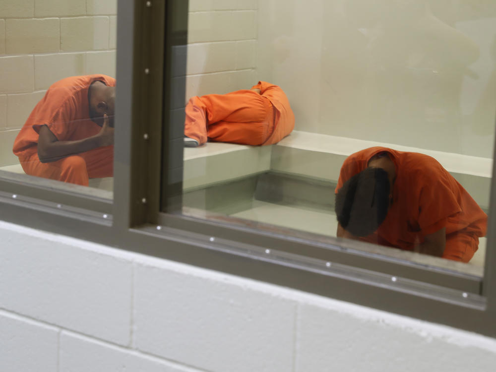 Immigrants await processing at an Immigration and Customs Enforcement (ICE) detention center in Adelanto, California. By filing a lawsuit under the Freedom of Information Act, NPR obtained a trove of inspection reports detailing serious problems at this ICE facility and others across the United States.