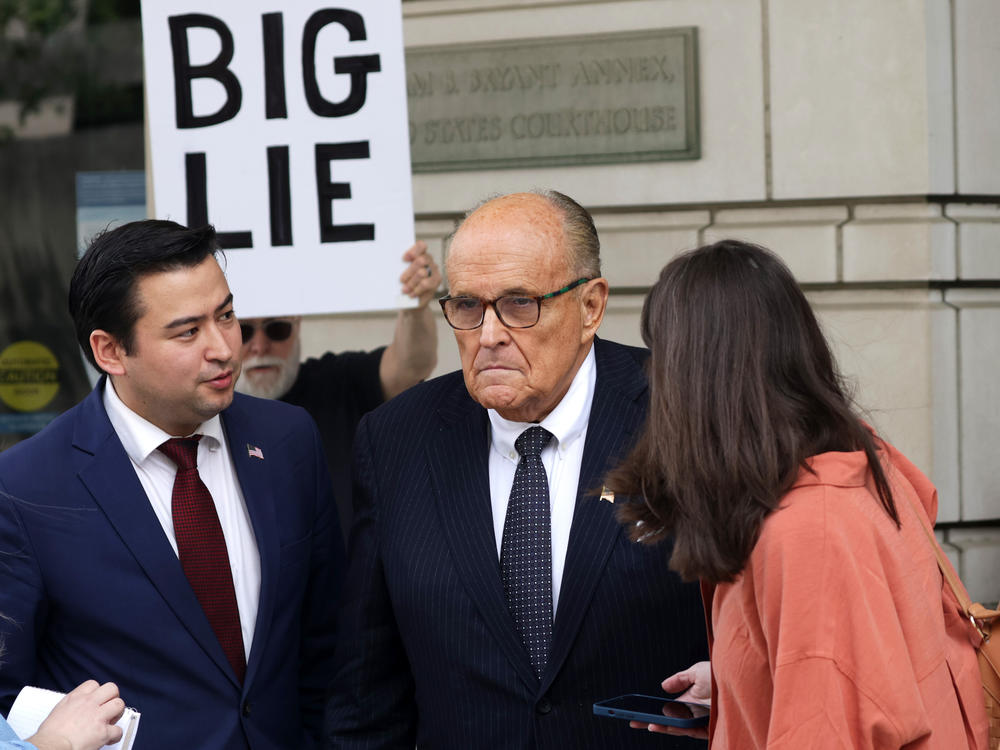 Rudy Giuliani, former New York City Mayor and Trump's former personal lawyer, talks to members of the press outside a Washington, D.C., court in May.