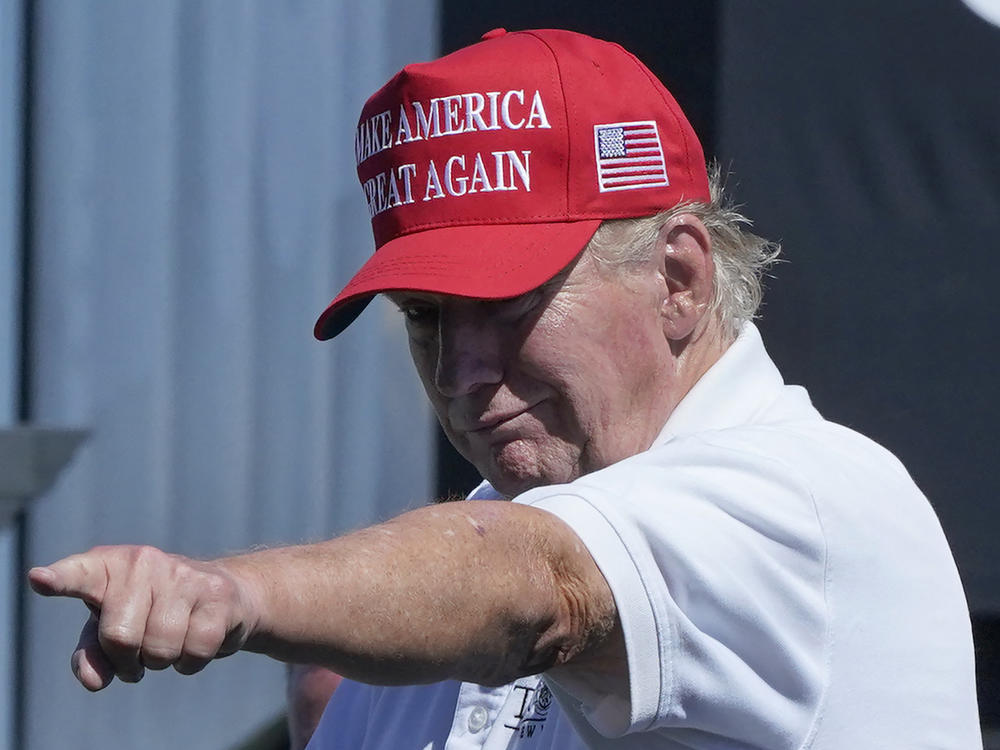 Former President Donald Trump points at a crowd at a golf tournament at Trump National in Bedminster, N.J., on Sunday.