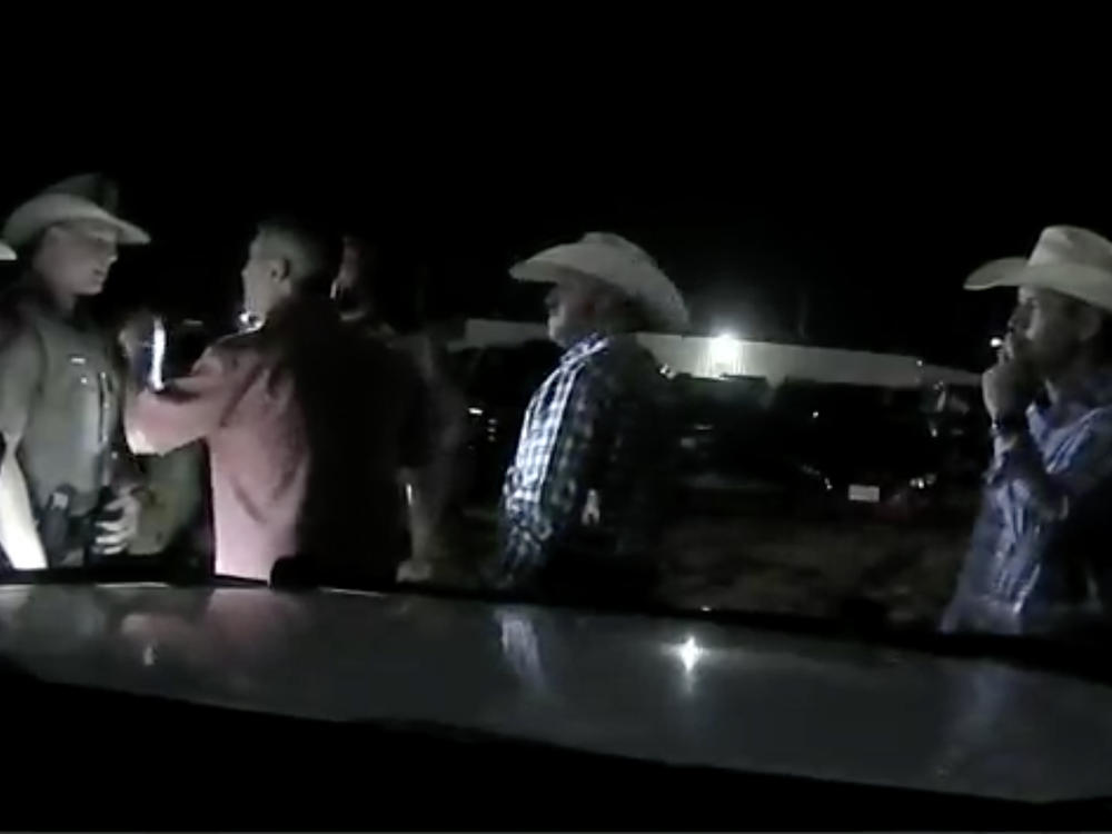 Texas authorities released body camera and dashboard video in which Rep. Ronny Jackson, in red shirt, yells profanities at deputies and troopers at a rodeo.