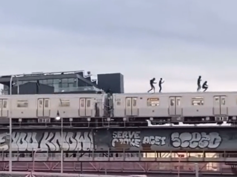 A screenshot from a video uploaded to TikTok by @big.ebk, which has since been removed, shows subway surfers in New York City. Four teens have died performing the dangerous stunt in the city this year.
