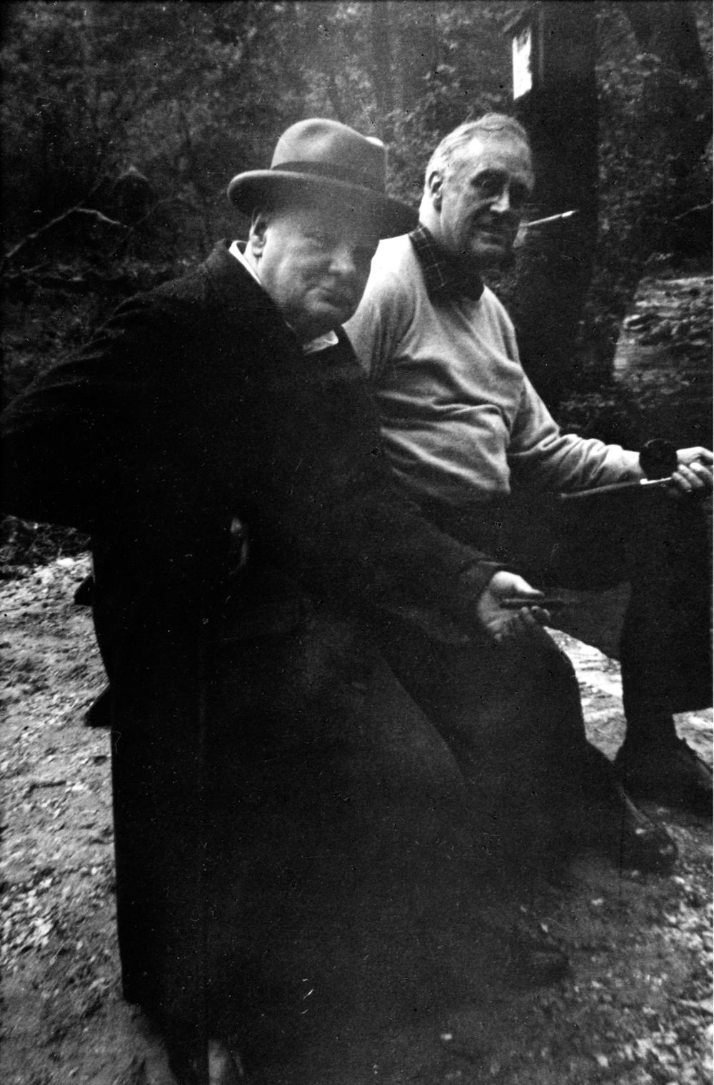 British Prime Minister Winston Churchill and President Franklin D. Roosevelt fishing in a stream at Camp David in May 1943. The presidential retreat was known as 
