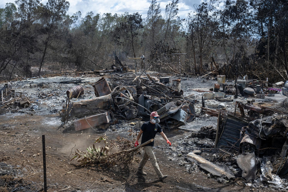 Gabriel Morgan, a surfer from Kihei volunteers to help people who have lost their homes in the Upcountry Fire. He is cleaning up Ross Hart's property. The surf shop where he worked, Jaw Surf in Lahaina burned down.