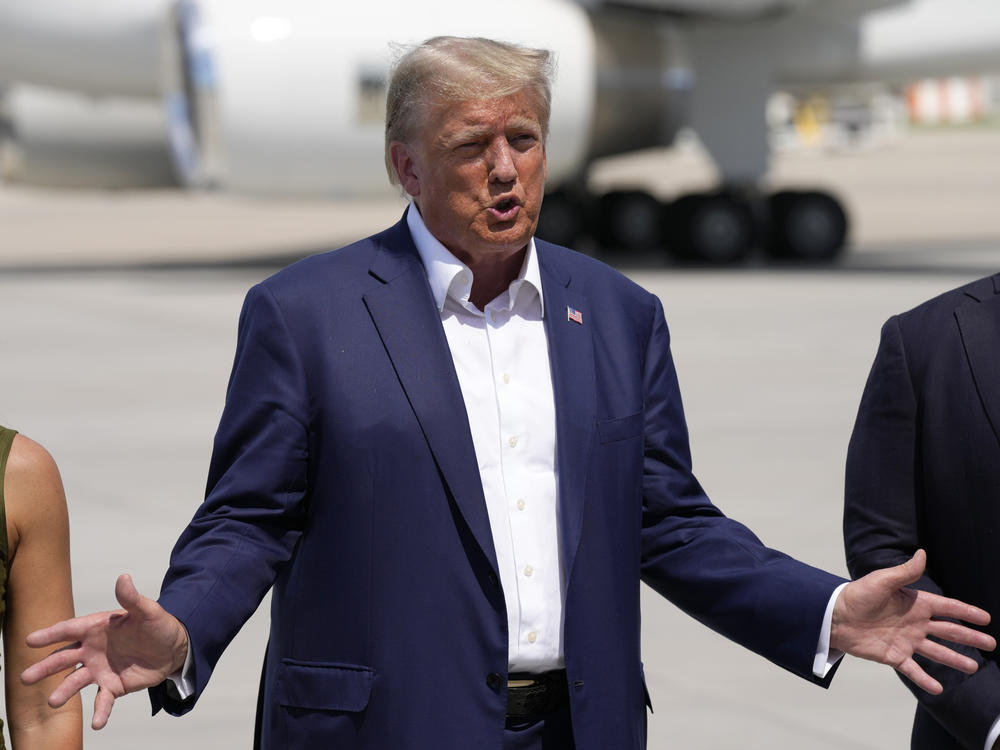 Republican presidential candidate former President Donald Trump speaks to reporters at the Des Moines International Airport after a visit to the Iowa State Fair on Saturday in Des Moines, Iowa.