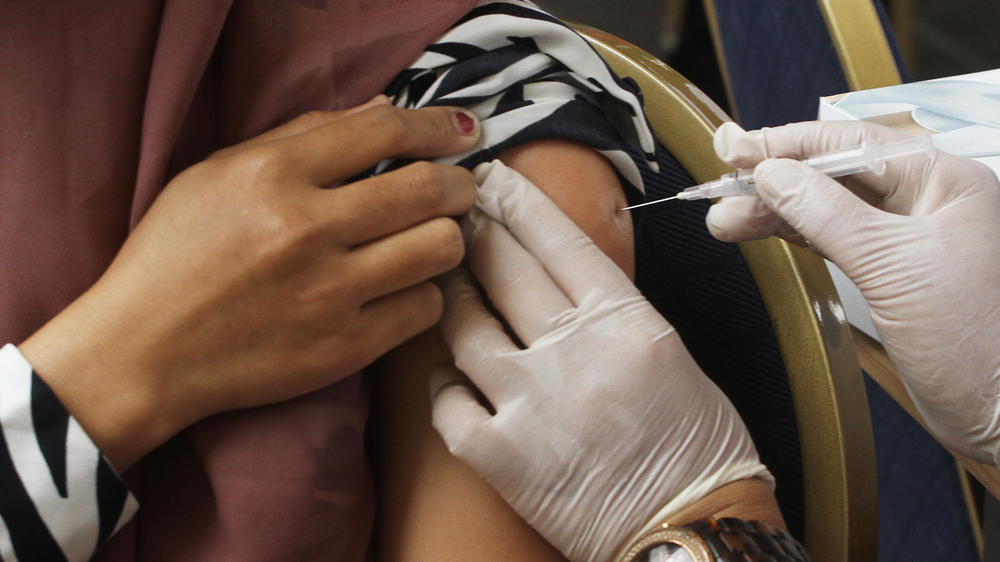 A COVID booster is administered in Jakarta, Indonesia.