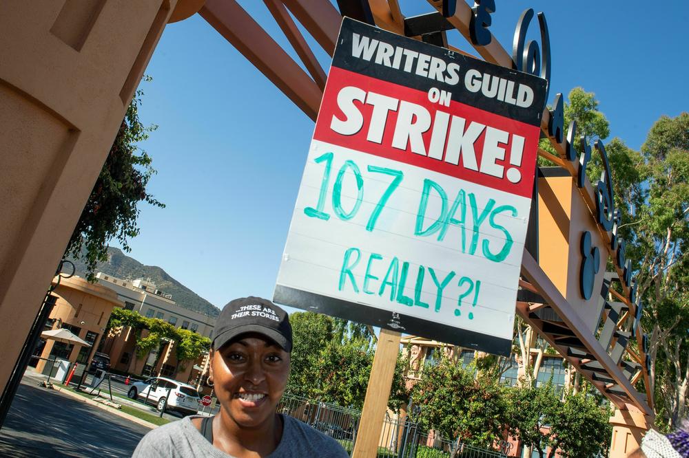 Members of the Writers Guild of America (WGA) and the Screen Actors Guild (SAG-AFTRA) walk the picket line outside of Disney Studio, in Burbank, California, on August 16.