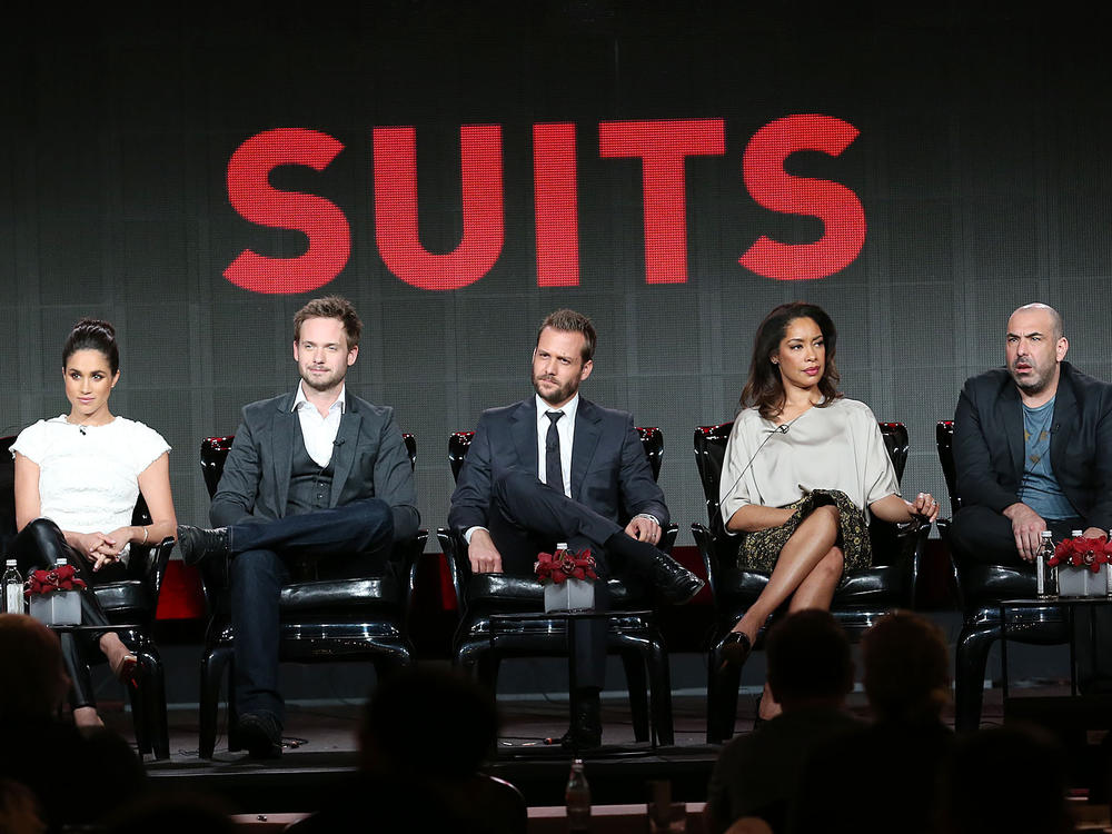 (From left) executive producer Aaron Korsh sits with actors Meghan Markle, Patrick J. Adams, Gabriel Macht, Gina Torres, Rick Hoffman and Sarah Rafferty of the TV show <em>Suits</em> in 2014.